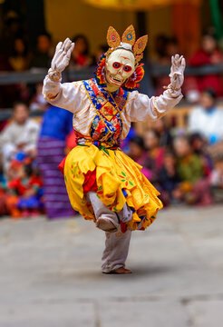 Bhutan, in the village of Bumthang, a monk mask dancer in his colourful costume dances at the festival of Jakar.