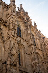 Obraz premium Ancient gothic church cathedral facade exterior stone arch carving spire vertical view. 