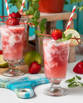 Glasses of freshly made strawberry daiquiri swirl mocktails, ready for drinking.