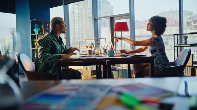 Man woman colleagues collaborating designs office desk, exchanging papers