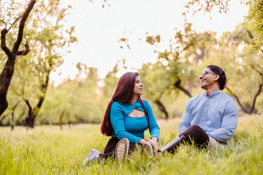 Latino couple communicating outdoors, man having prosthetic legs