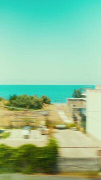 Beach holiday houses in Calabria seen from a train travel window