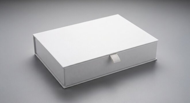 A high-angle mockup of a solid white rigid gift box with a matte finish and ribbon tab on a neutral grey background.