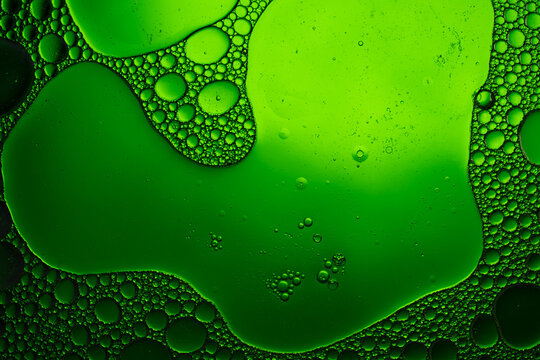 Green oil bubbles creating abstract flowing pattern
