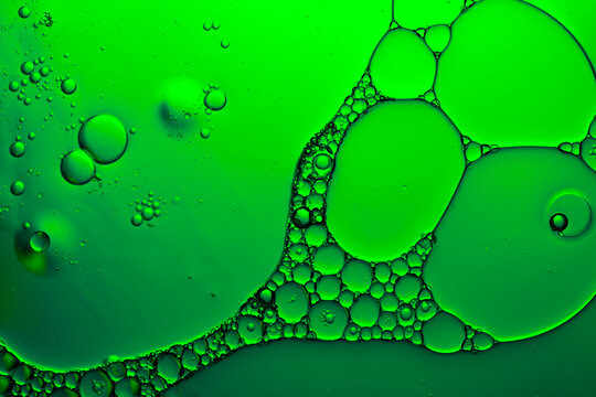 Green oil and water bubbles abstract macro pattern