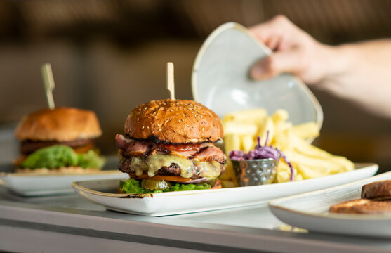 Gourmet Burger Served With Crispy Fries in a Vibrant Restaurant Setting