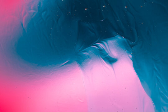 Abstract fluid gradient mixing blue and pink colors