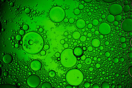 Green oil and water emulsion forming abstract pattern
