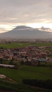 Stunning sunset over Hirosaki city residential area with majestic Mt. Iwaki in the background