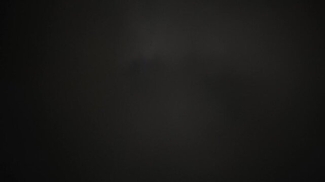 The moon tries to shine but the dense clouds don't let him