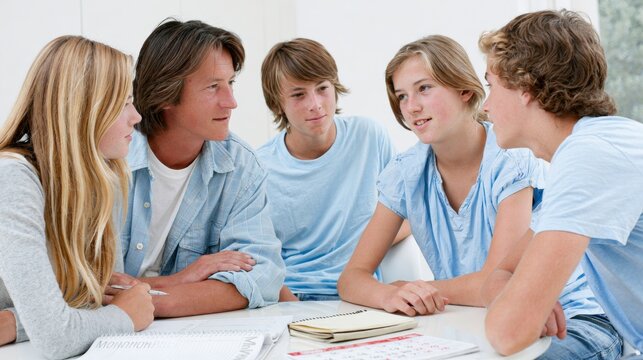 Parents and teenagers discussing important family decision together at home. Open communication, trust, guidance, problem solving and supportive parenting