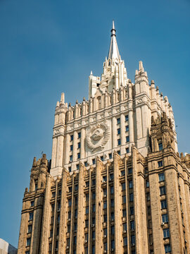 Ministry of Foreign Affairs of Russia building in Moscow, Stalinist architecture skyscraper with Soviet emblem against a blue sky.