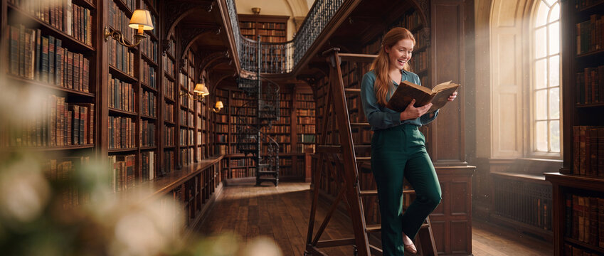 Woman reading book in historic library, illuminated by warm sunlight streaming through high windows onto dark wood shelves, ideal for education and literature campaigns