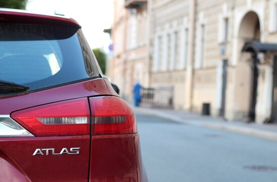 The 30th of July Saint Petersburg Russia back side of dark red Geely Atlas car automobile city photo 