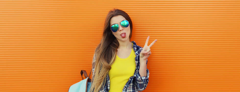 happy cheerful stylish young woman posing against background