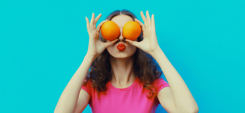 Summer, nutrition, diet and vegetarian concept. Happy cheerful woman covering her eyes with fruits
