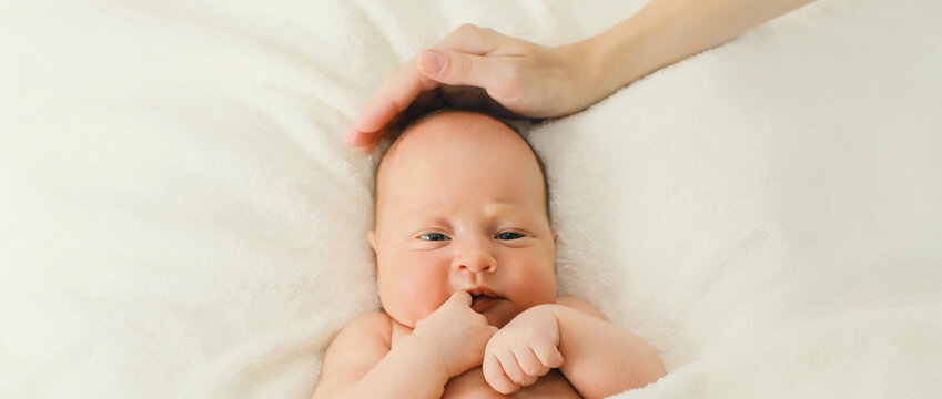Portrait of infant sweet sleeping lying on white bed at home