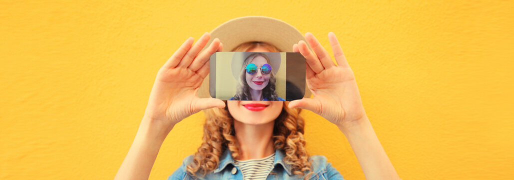 happy young woman taking selfie with phone