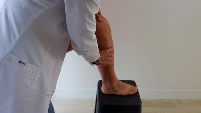 Nutritionist measuring an obese patient's leg during medical checkup