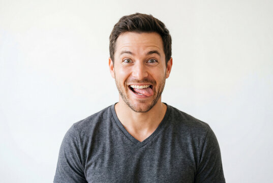 Smiling man making a funny face by sticking out his tongue