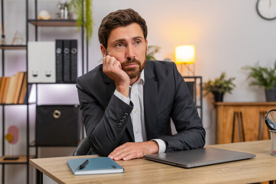 Middle-aged businessman at home office shuts laptop fast and annoyed by boring task. Freelancer guy at table rubs eyes stretches takes short break then returns to work focused calm again.