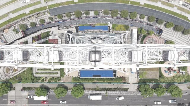 Title: Aerial top-down view hovering over Ferris wheel structure, shot in D-Log M