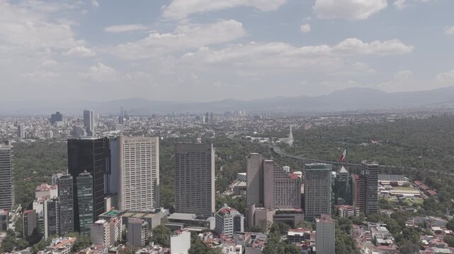Aerial panoramic view of Polanco hotel district skyline with Bosque de Chapultepec, Campo Marte and Auditorio Nacional in background, shot in D-Log M