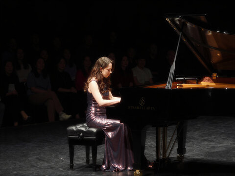 Pianist Performing Under Spotlight