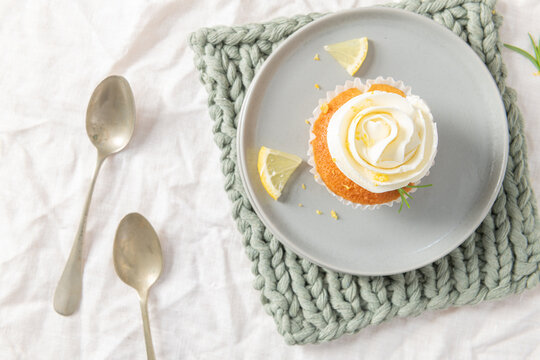Lemon cupcake with white frosting from top view