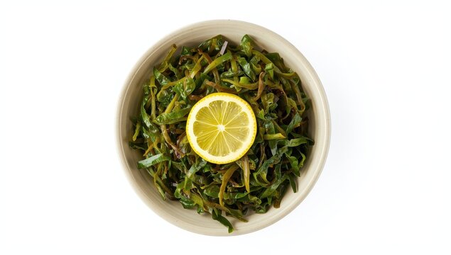 Closeup of a bowl containing seaweed salad and a slice of lemon on a white background.