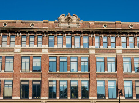 Newark, NJ - US - Jul 26, 2026 The detailed brick and stone facade of the historic Hahne and Company building, showcasing rows of windows beneath an ornate decorative roof crest.
