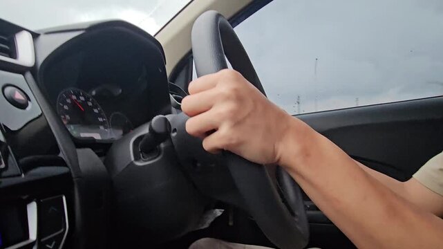 This is a hand on the wheel on the highway