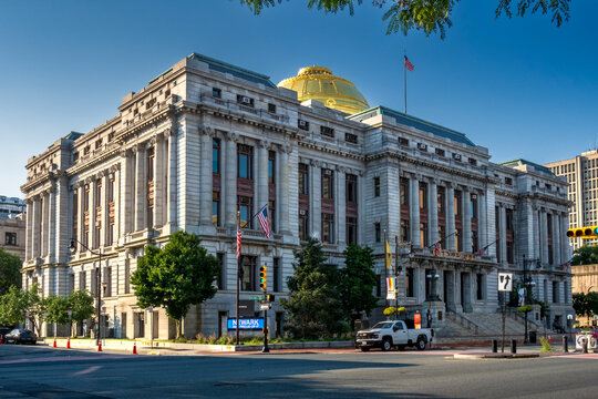 Newark, NJ - US - Jul 26, 2026 Angled view of Newark City Hall showcasing its grand neoclassical architecture, ornate columns, and gold dome under clear blue sky at a quiet downtown intersection.