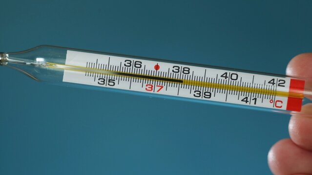 Close up of a mercury thermometer showing a temperature reading of 37 degrees Celsius