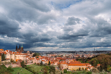 Fototapeta premium Prague skyline with dramatic clouds. Cityscape View From Strahov Monastery. Concept of time passing, urban rhythm and historic European architecture. 