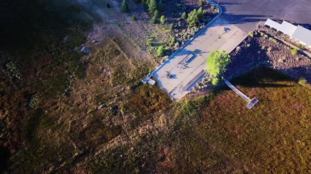 Tight drone orbit over dry Gallatin Marina boat ramp at Eagle Lake, Lassen County, California, panning up to reveal water receded far from launch due to drought.