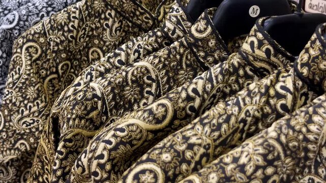 Traditional Saudi embroidered Bisht clothing with ceremonial golden dagger (Jambiya) hanging on display