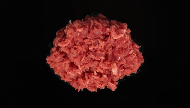 Ground pork on a dark backdrop, overhead shot.