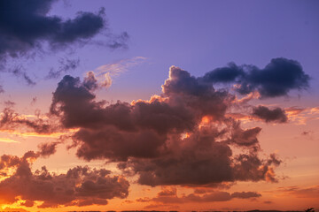 Fototapeta premium Dramatic Purple and Orange Sunset Clouds Across the Evening Sky