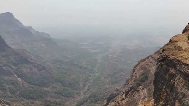 Ratangad cliff and hazy Sahyadri valley aerial Maharashtra India