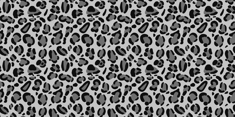 Monochromatic grey leopard skin print landscape surface. Sleek charcoal feline spot fur texture for cool winter apparel and a wide wrapping paper design. © MDC