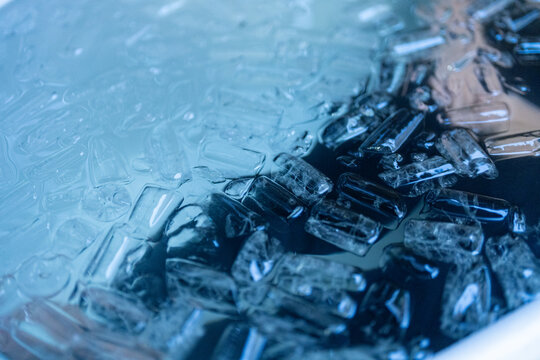 Athlete performing cold plunge recovery in an ice-filled tub to support muscle recovery, endurance, and physical performance. Excellent for sports medicine and wellness themes.
