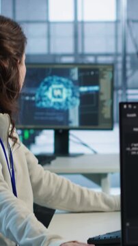 Woman responds to computer crash during data center work, combining bug fixing, support escalation and technical pressure from camera A angle.