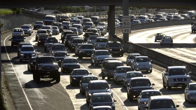 Heavy highway traffic jam on a sunny day, cars backed up for miles.