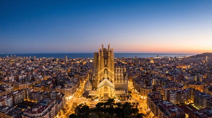 Aerial view of Barcelona city at sunset. Famous cathedral illuminated in urban landscape. © StockPoly 3D