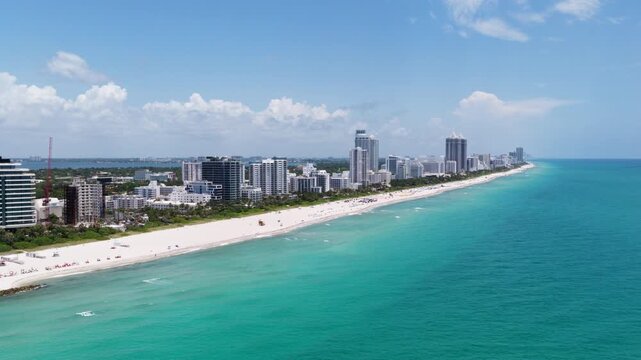 Miami skyscrapers above the coastline. Miamis coastal landscape from above. Top view of Miami shoreline. Aerial view of Miami beach and ocean. Tropical Miami coastline.