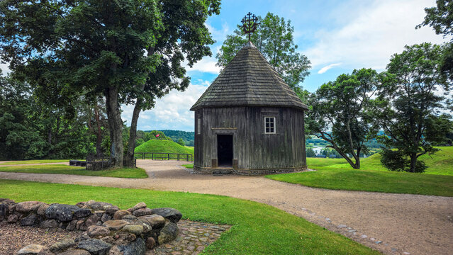 Historic Wooden Chapel in Scenic Green Landscape