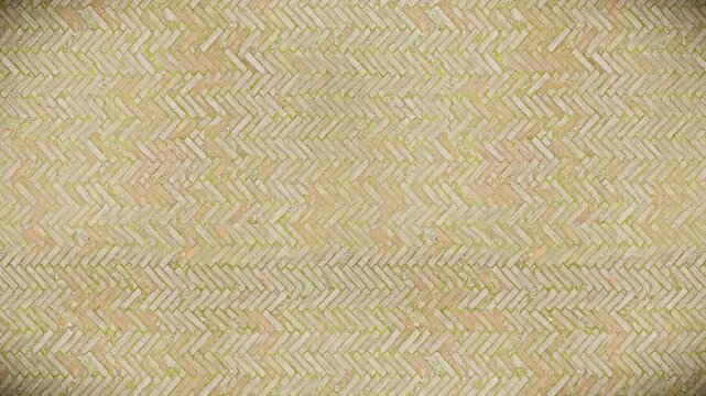 Weathered herringbone brickwork texture offers a seamless loop background.