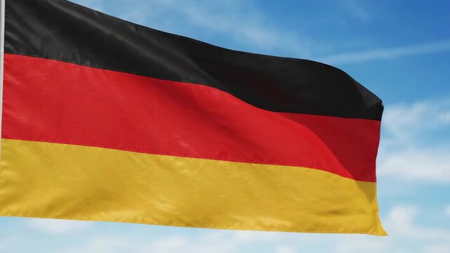 German flag waving against blue sky