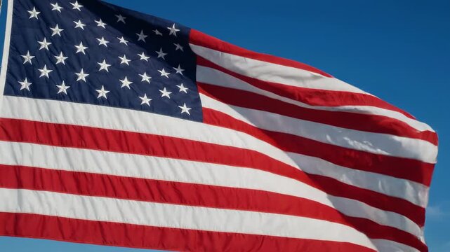 American flag waving in blue sky